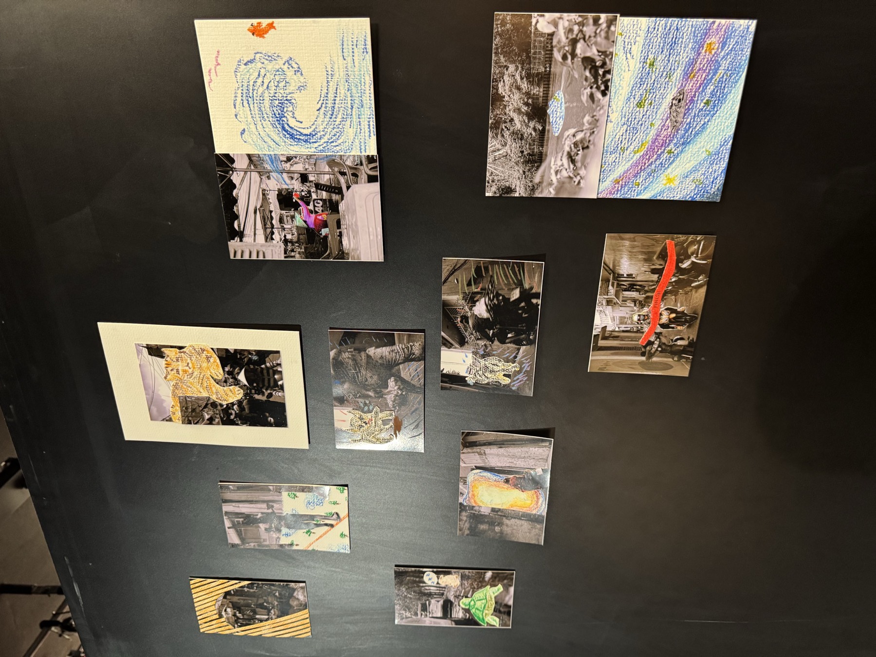 Framed photographic works hung on a black wall