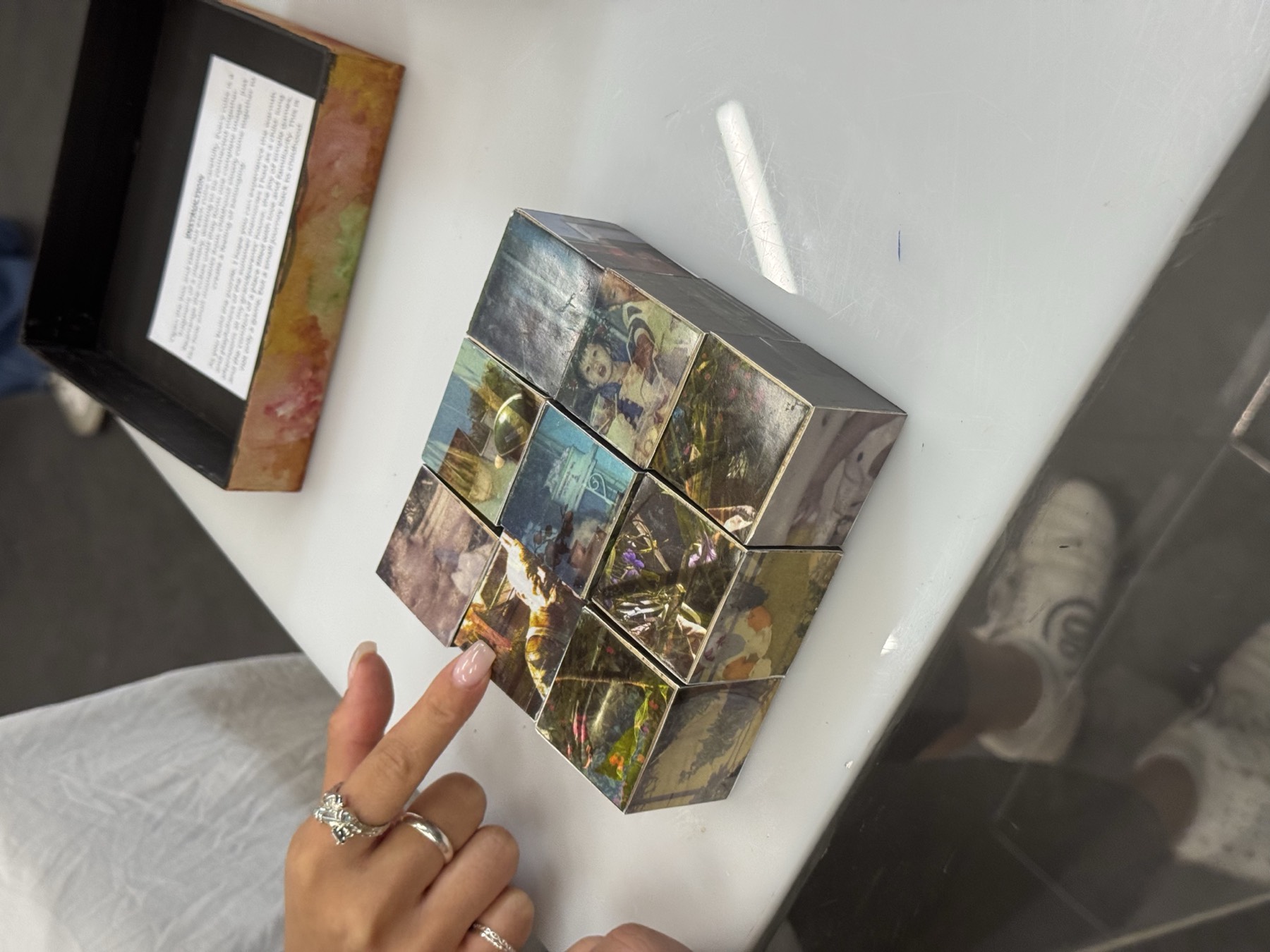 Painted cube tiles arranged as an interactive work on a table